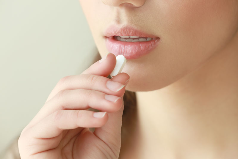 Dental Patient Taking A Dental Sedative Pill