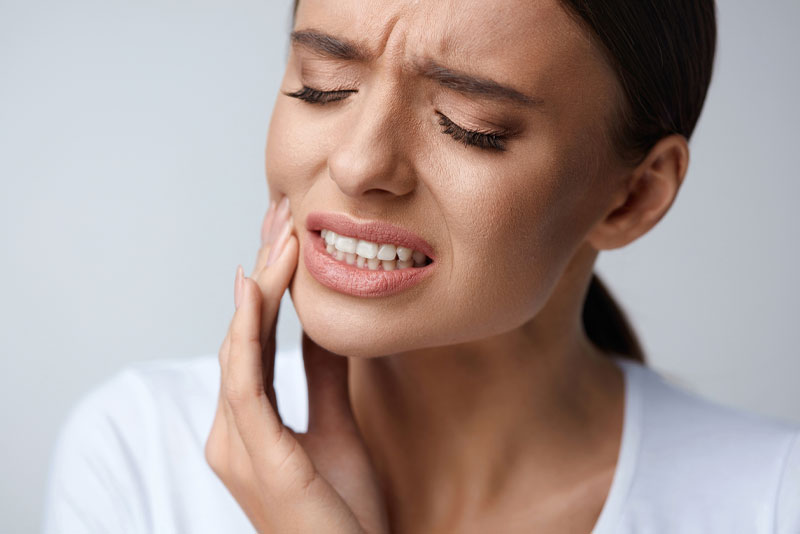 Dental Patient In Pain From Needing Her Wisdom Teeth Extracted