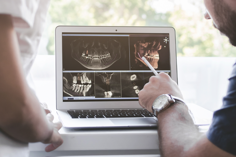 Doctor Showing A Dental Patient An XRay Of Facial Trauma