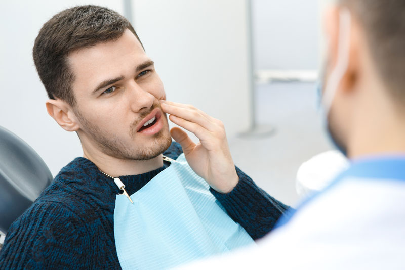 Dental Patient Suffering From Mouth Pain On A Dental Chair, In Sandwich, MA
