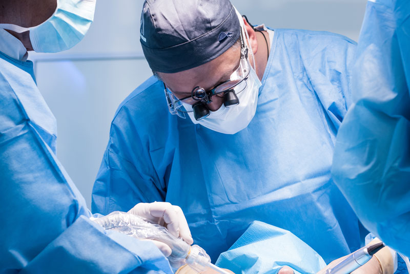 Oral Surgeon Performing Dental Procedures