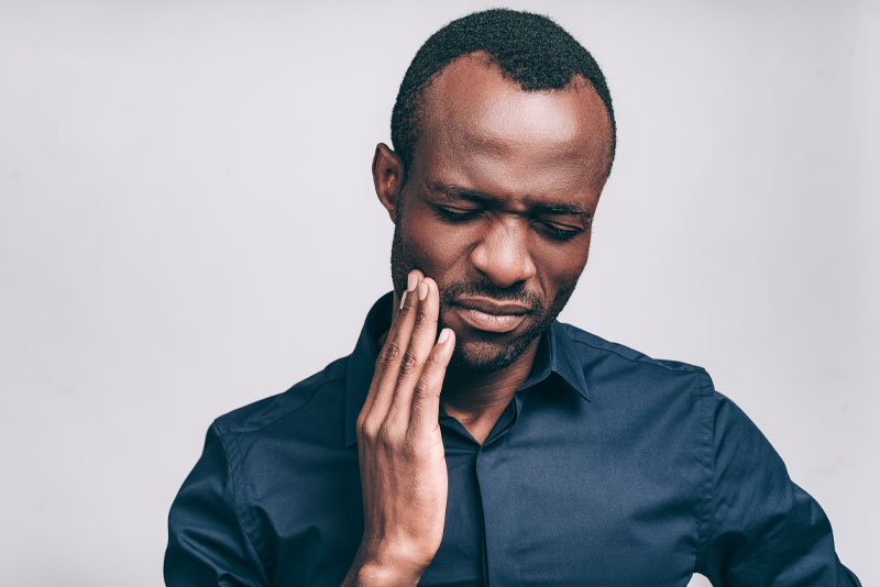 a dental patient experiencing tooth and jaw pain