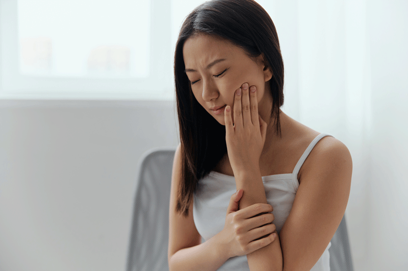 young women unhappy suffering from hurting tooth.