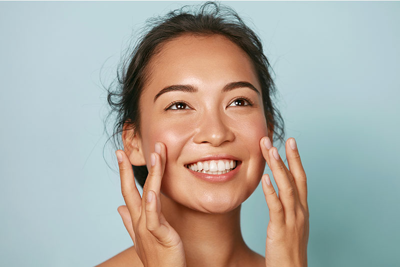 women with beautiful Radiant skin smiling brightly