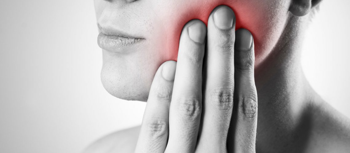 an image of a person with wisdom tooth pain.