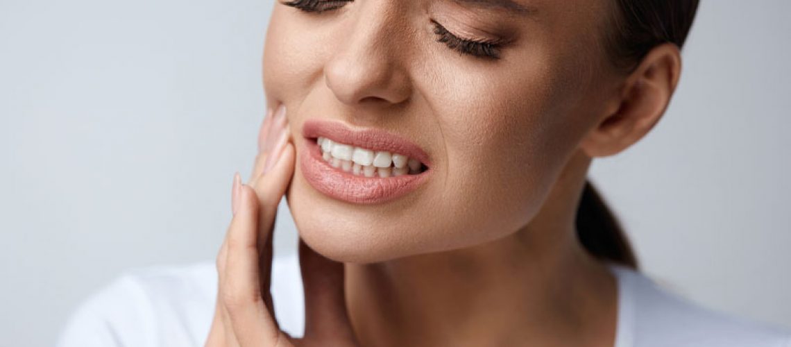 Dental Patient In Pain From Needing Her Wisdom Teeth Extracted