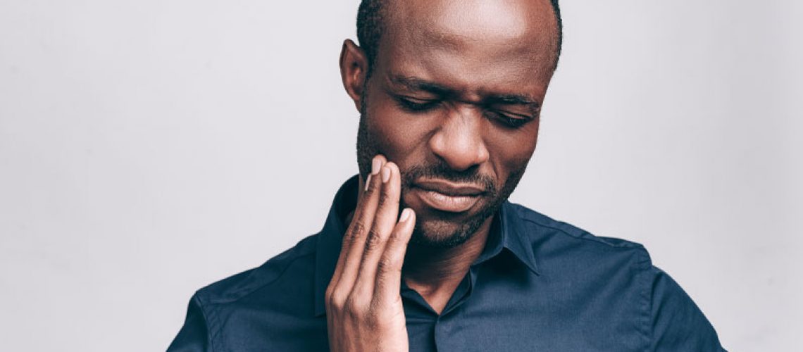 a dental patient experiencing tooth and jaw pain